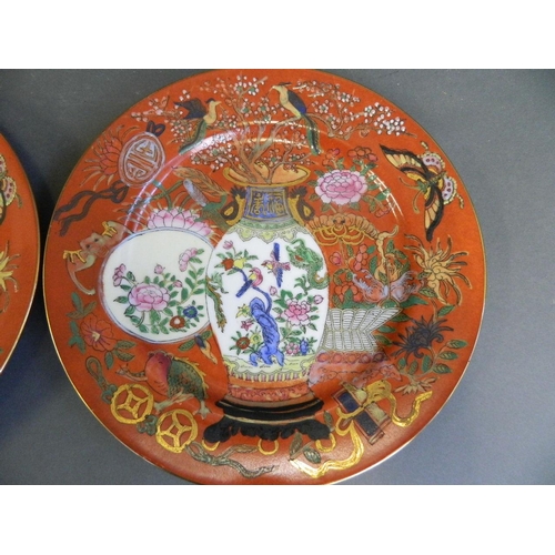 241 - A pair of Chinese polychrome enamelled porcelain cabinet plates decorated with objects of virtue and... 