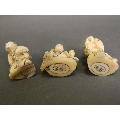 242 - A collection of three Japanese carved bone netsuke figures, signature to bases, 2