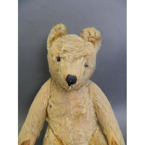 244 - A straw filled plush teddy bear with movable limbs and inset glass eyes, 15