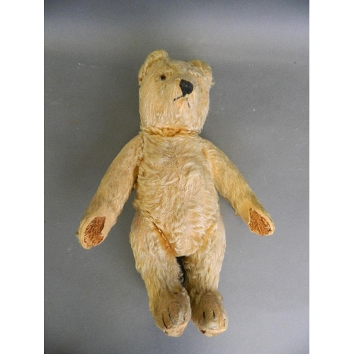 244 - A straw filled plush teddy bear with movable limbs and inset glass eyes, 15