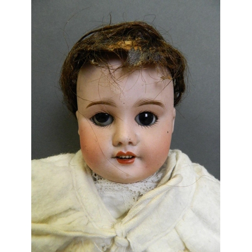 248 - An early C20th Bisque headed doll with an open mouth and four upper teeth, weighted brown eyes and a... 