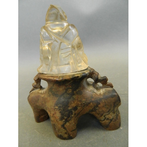 250M - A rock crystal figure of Buddha seated on a carved soapstone base, 4