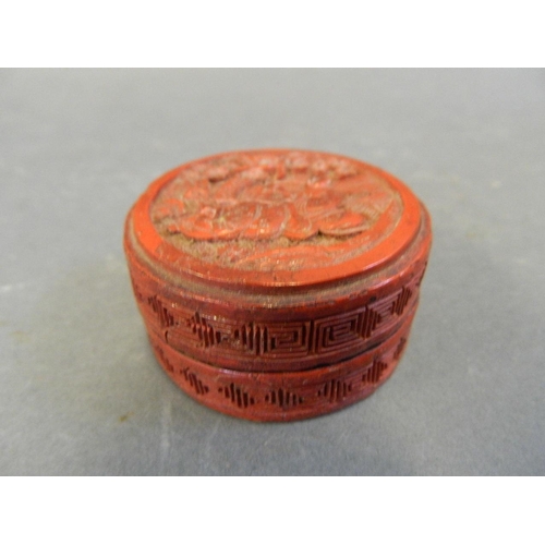 250R - A small cinnabar lacquer pill box decorated with figures in a garden, 2