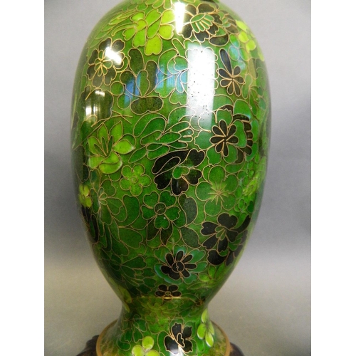 253 - A Chinese green ground cloisonné vase with all over floral decoration, together with two smaller clo... 