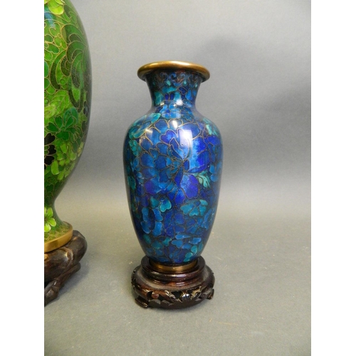 253 - A Chinese green ground cloisonné vase with all over floral decoration, together with two smaller clo... 