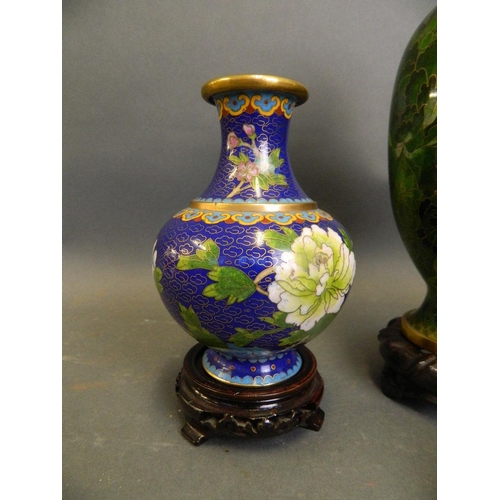 253 - A Chinese green ground cloisonné vase with all over floral decoration, together with two smaller clo... 