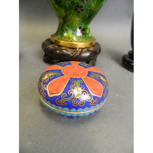 253 - A Chinese green ground cloisonné vase with all over floral decoration, together with two smaller clo... 