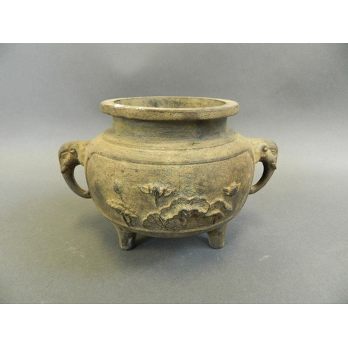 263 - A Chinese bronze censer with twin elephant mask handles and relief decoration of lilies and figures,... 