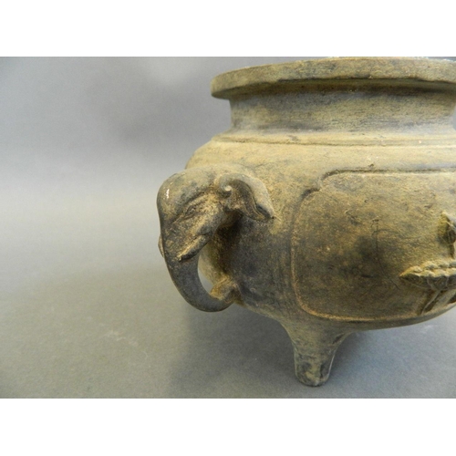 263 - A Chinese bronze censer with twin elephant mask handles and relief decoration of lilies and figures,... 