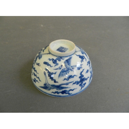 280 - A Chinese blue and white porcelain tea bowl decorated with storks in flight, seal mark to base, 3½