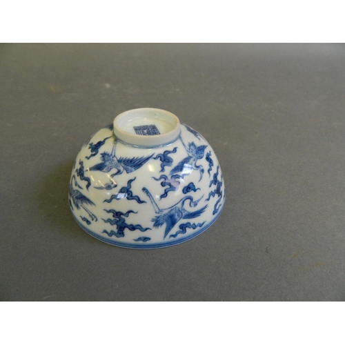 280 - A Chinese blue and white porcelain tea bowl decorated with storks in flight, seal mark to base, 3½