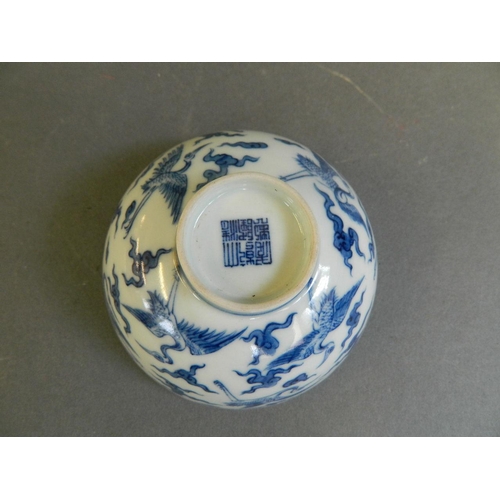 280 - A Chinese blue and white porcelain tea bowl decorated with storks in flight, seal mark to base, 3½