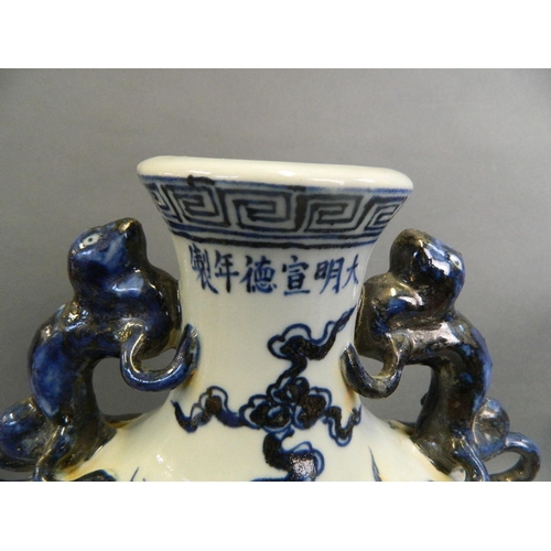 292 - A Chinese blue and white porcelain moonflask with twin kylin handles and painted decoration of a dra... 