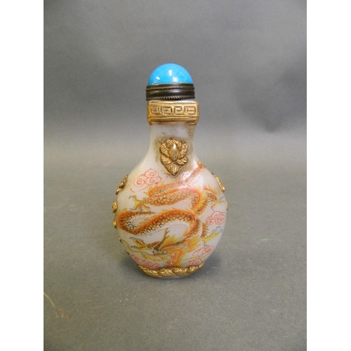 294 - A Chinese glass snuff bottle with applied carved and gilt dragon decoration, 2 character mark to bas... 