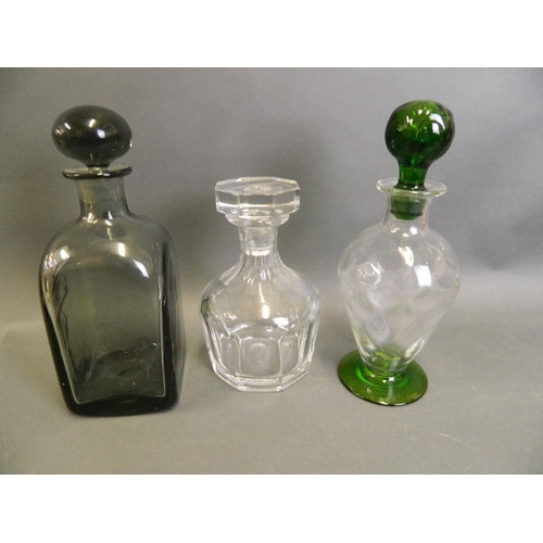 31 - A square section smoky blown glass decanter with globular stopper, a baluster shaped decanter with g... 