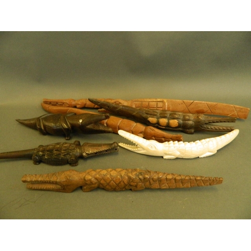 316 - A collection of carved African figures of crocodiles, including ebony and bone, longest 15½