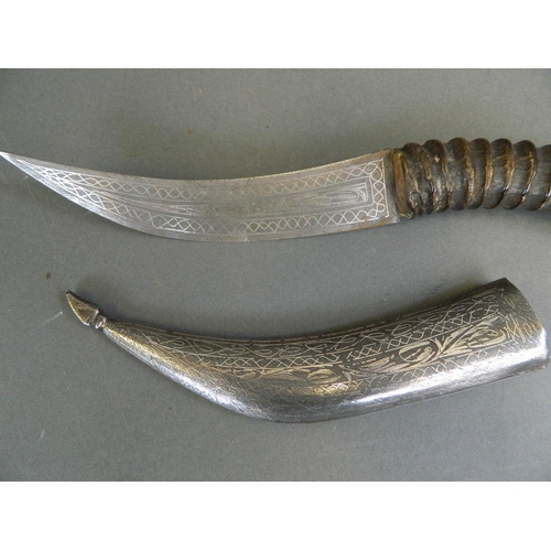 328 - An Middle Eastern horn handled dagger with a blade and scabbard decorated in the Bidri style, 14