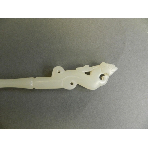 340 - A Chinese white jade hairpin with carved dragon decoration to handle, 8½