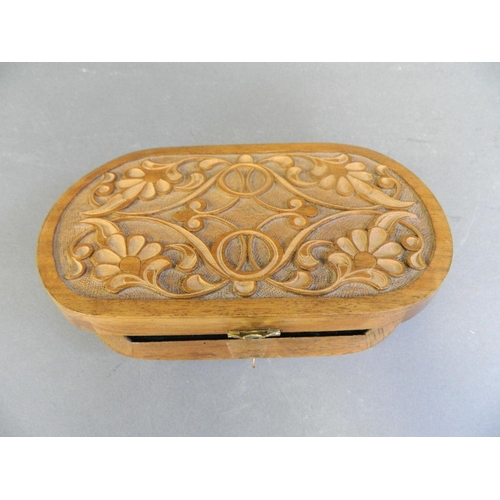 350A - A carved wood box fitted with horn shaped scissors and folding 'butterfly' knife, from the workshop ... 