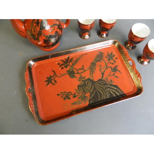 350W - A Chinese red ground porcelain wine ewer with matching cups, together with a similar tray with black... 