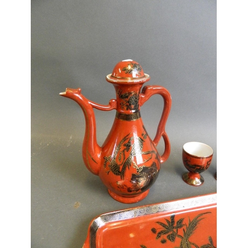 350W - A Chinese red ground porcelain wine ewer with matching cups, together with a similar tray with black... 