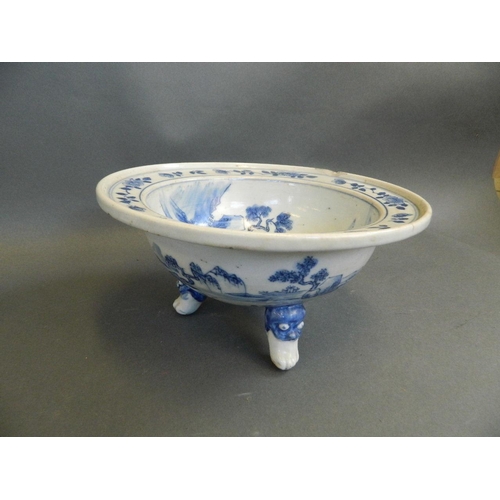 351 - A Chinese blue and white porcelain bowl decorated with fishermen in a boat on a lake, on three kylin... 