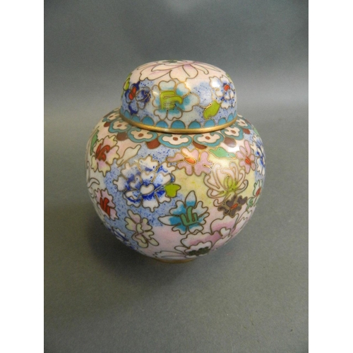 357 - An Oriental cloisonné ginger jar and cover decorated with bright enamelled flowers on a pale ground,... 