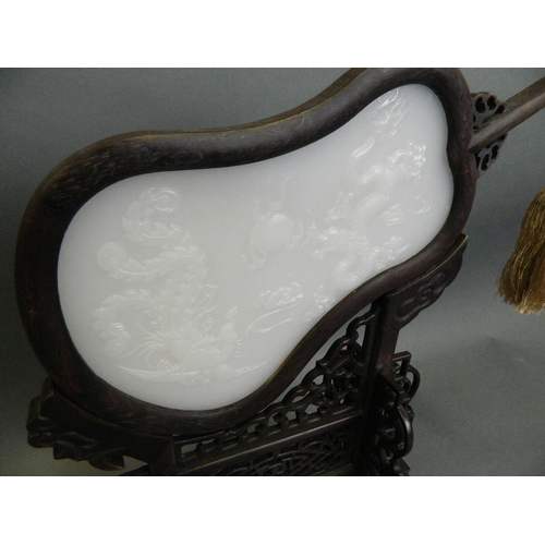 360 - A Chinese white jade and carved hardwood table screen in the form of a fan with carved dragon and ph... 