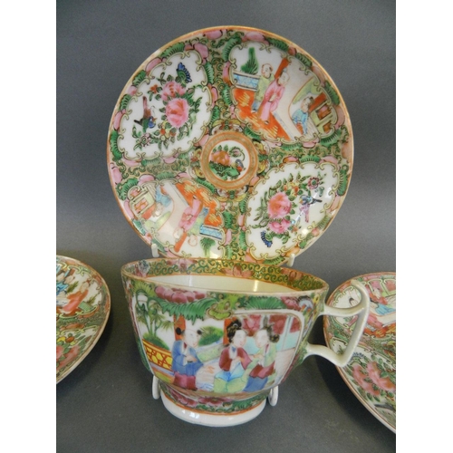 372 - A C19th Chinese famille rose porcelain cup and saucer with decorative panels of figures in a garden ... 