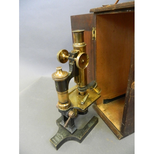 375H - A C19th 'Eclipse' microscope no. 6184, of brass construction, on a cast iron base, in original wood ... 