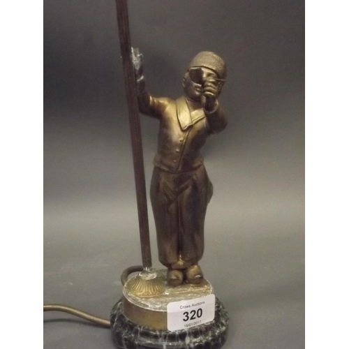 375U - An early C20th bronzed metal table lamp in the form of a young pipe smoker, mounted on a marble base... 