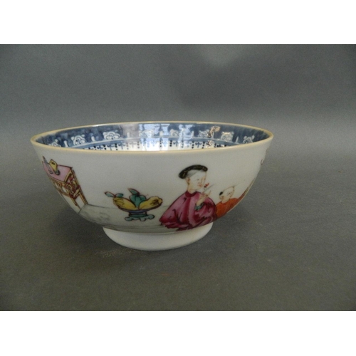 378 - A Chinese porcelain bowl decorated with figures in a garden joined by a boy climbing through a windo... 