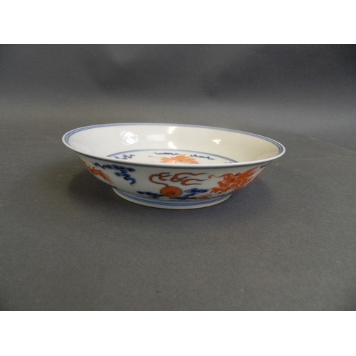 392 - A Chinese blue and white porcelain dish with red enamel dragon and flaming pearl decoration, 6 chara... 