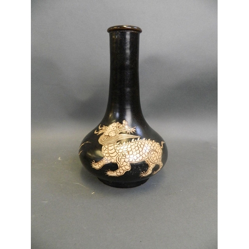 399 - A Chinese Cizhou kiln bottle vase with incised twin kylin decoration, 11