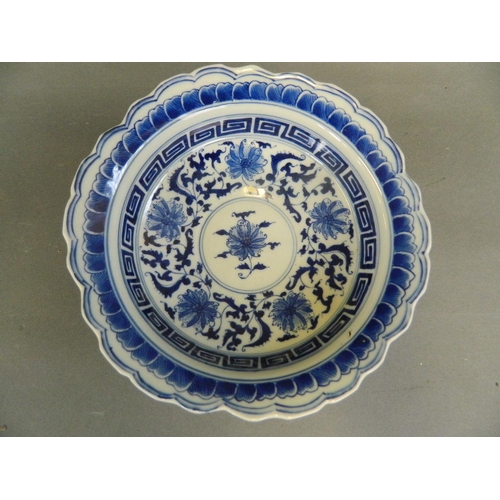 411 - A Chinese blue and white porcelain stem bowl with frilled rim and painted floral decoration, 6½