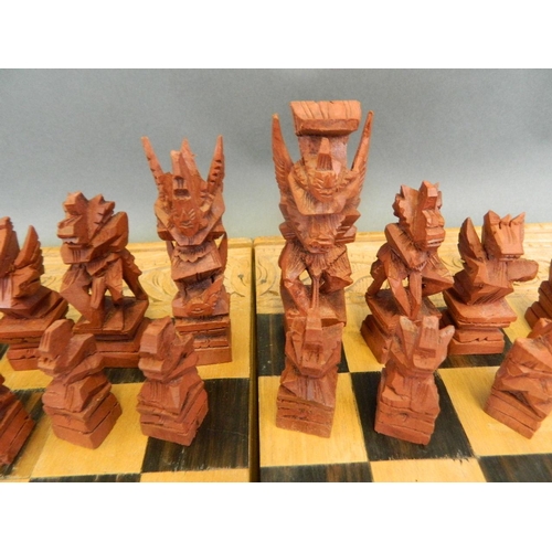 417 - A complete chess set with unusually carved pieces in the form of mythical beasts, in a decorative ca... 