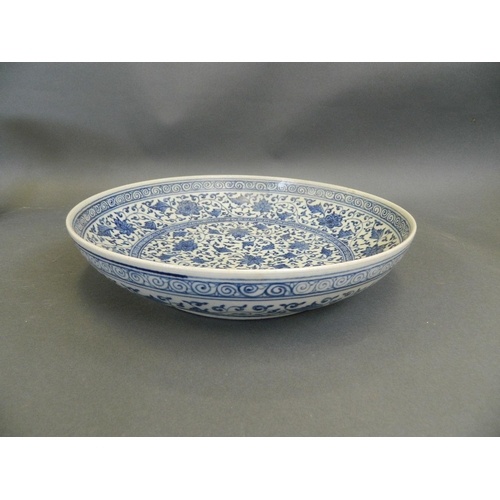 423 - A Chinese blue and white porcelain charger with scrolling foliate decoration, seal mark to base, 12