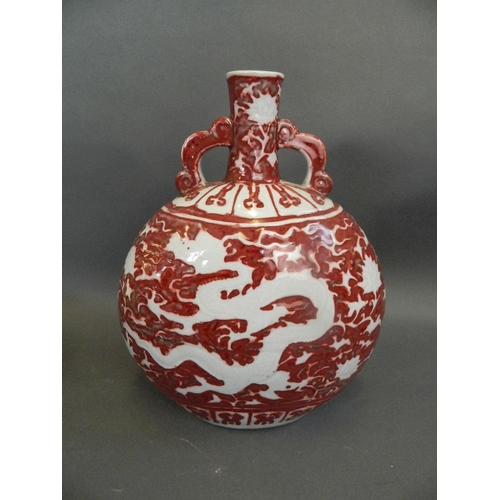 439 - A Chinese red and white twin handled moonflask with incised dragon decoration, 12