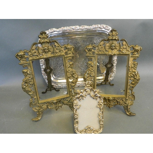 441 - Two ornate cast metal easel photo frames, together with a smaller cast frame, and a silver plated tr... 