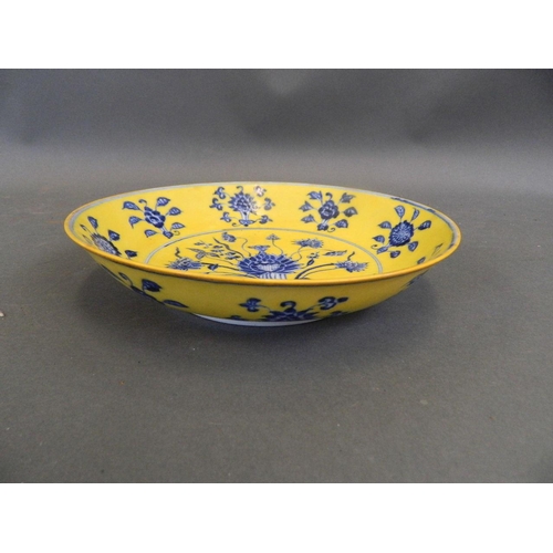 465 - A Chinese yellow ground porcelain cabinet plate with floral decoration in the blue and white palette... 