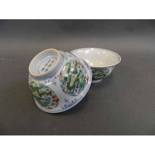 469 - A pair of Chinese Doucai enamel porcelain rice bowls with dragon and flaming pearl decoration, 6 cha... 