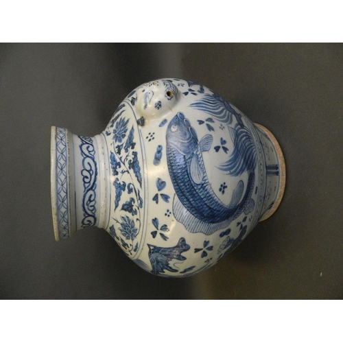 481 - A Chinese Ming style blue and white porcelain bulbous vase with twin mask handles and painted carp d... 