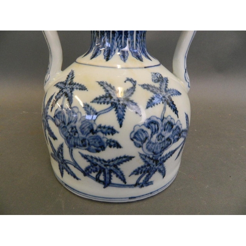 484 - A Chinese blue and white porcelain twin handled squat vase with floral decoration, 4 character mark ... 