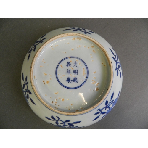 493 - A Chinese blue and white porcelain bowl decorated with a sage and two servants, 6 character mark to ... 