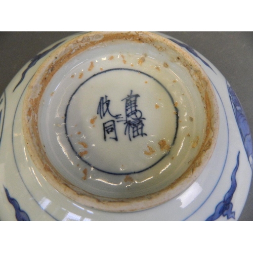 496 - A Chinese blue and white porcelain bowl with decorative panels depicting scholars, 4 character mark ... 