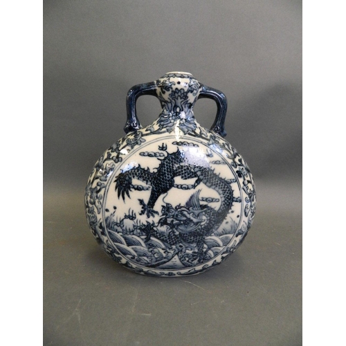 497 - A Chinese blue and white porcelain twin handled moonflask decorated with dragons chasing the flaming... 