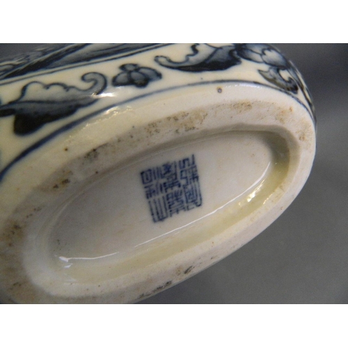 497 - A Chinese blue and white porcelain twin handled moonflask decorated with dragons chasing the flaming... 