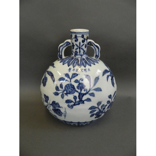 50 - A Chinese blue and white porcelain twin handled moonflask with painted fruiting branch decoration, 6... 