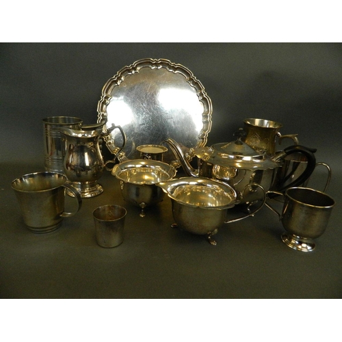 506 - A three piece silver plated tea set with petal shaped rims and raised on tripod feet, together with ... 