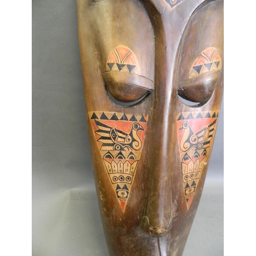 50E - A large African carved wood wall mask with painted animal decoration, c1950, 9½